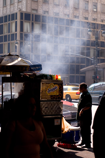 hot dog cart with uniformed guy